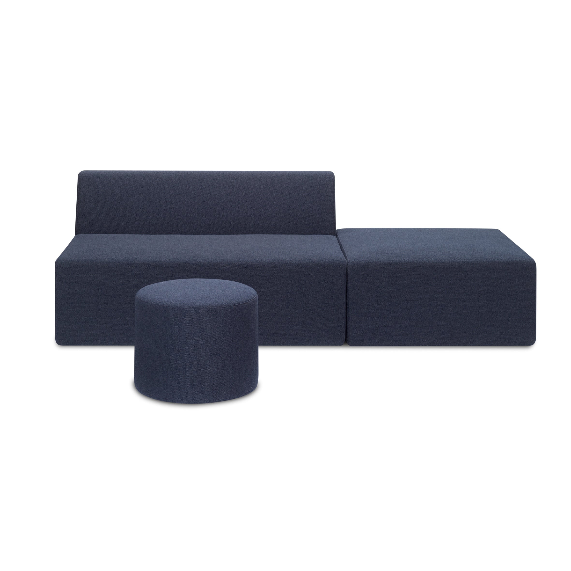 The minimalist modular arrangement includes the SF06 KERMAN from E15 in dark blue, featuring a low backrest, an attached right-side ottoman, and a separate round ottoman upfront. The seating modules have removable covers set against a plain white background.