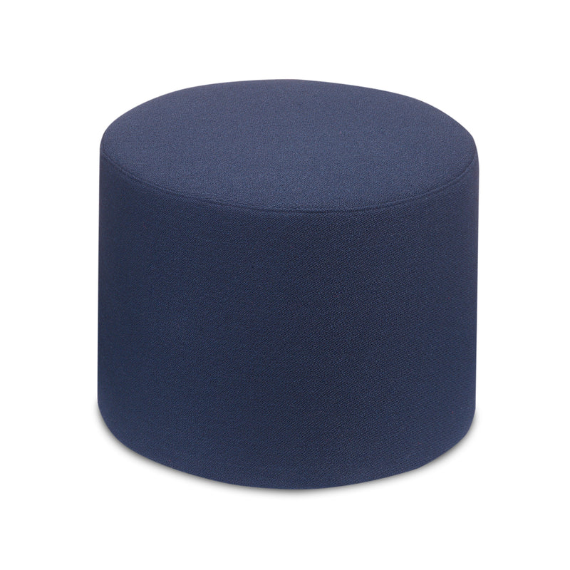 The SF06 KERMAN by E15 is a round, dark blue fabric ottoman with a simple cylindrical design on a white background. It offers extra seating or footrest use, featuring removable covers for easy maintenance and seamless integration with modular furniture systems.