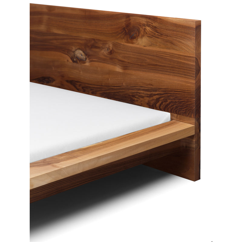 Close-up of the E15 SL02 MO designer bed with a solid wood frame showcasing natural brown grain. Its modern minimalist lines enhance the white mattress, making it ideal for those desiring elegance and simplicity in their bedroom.