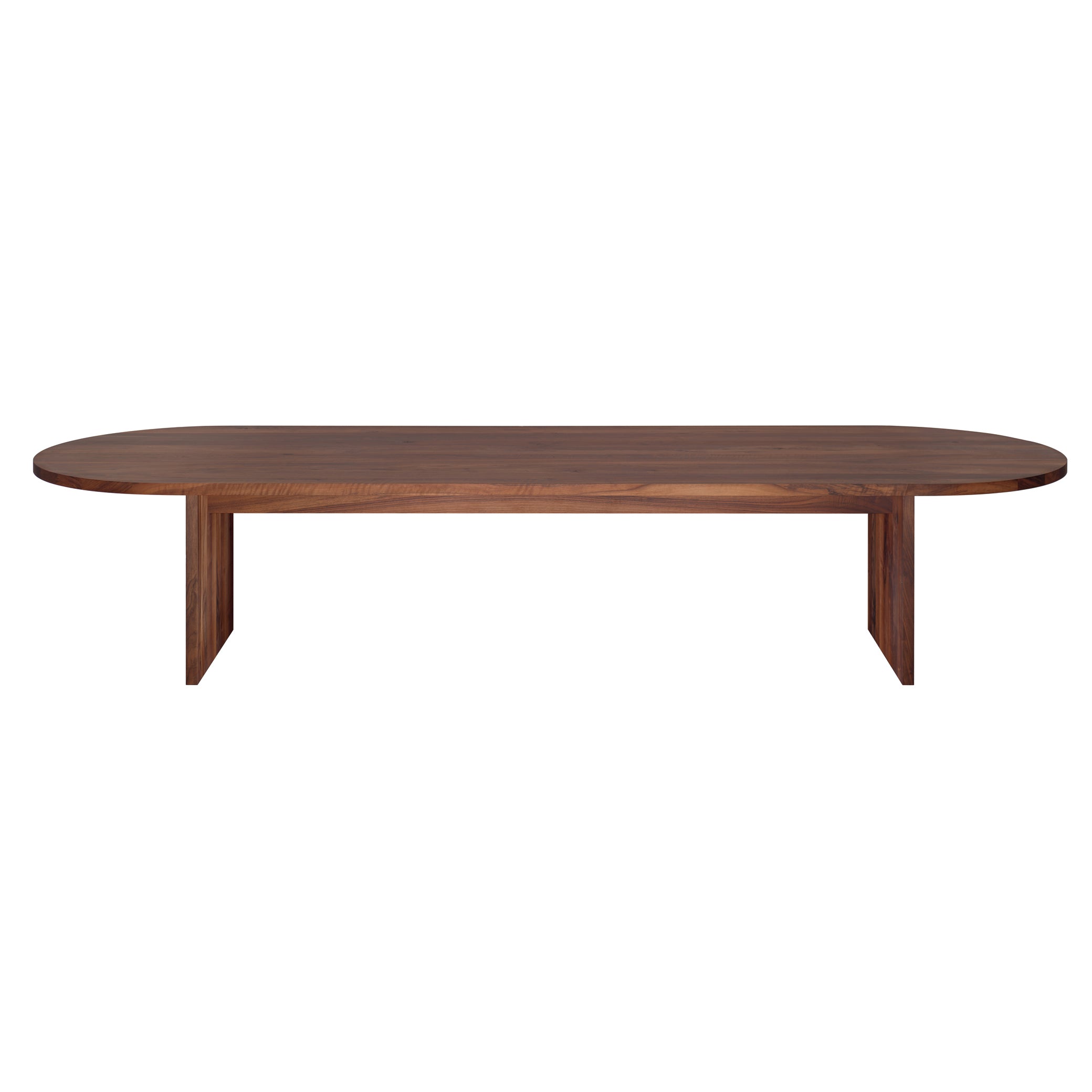 The TA24 ASHIDA Oval by E15 is a long, oval table made from solid European walnut, featuring a polished dark finish on its smooth surface and two sturdy rectangular legs, providing a striking contrast against a plain white background.