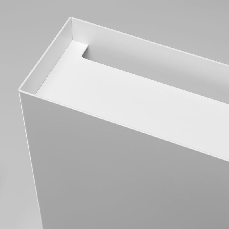 Close-up of a white rectangular BUSY wire manager by E15 on a light gray background, open at the top to reveal its depth and crisp edges. The minimalistic design features clean lines and a smooth, powder-coated aluminum surface.