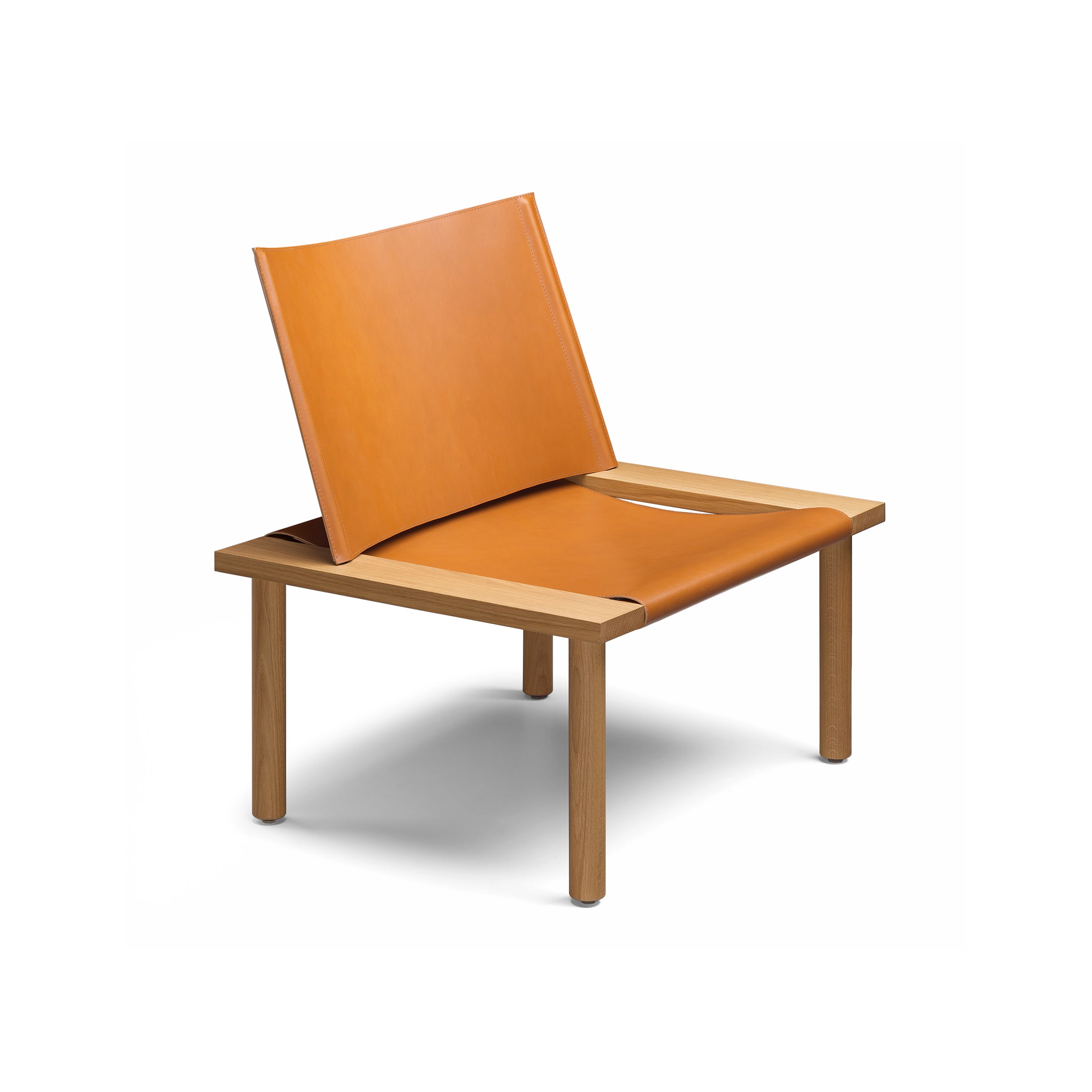 The EC06 ILMA Lounge Chair by E15 combines a minimalist design with a solid wood frame, featuring a low-profile, open-back structure made from smooth harness leather, highlighting its natural materials.