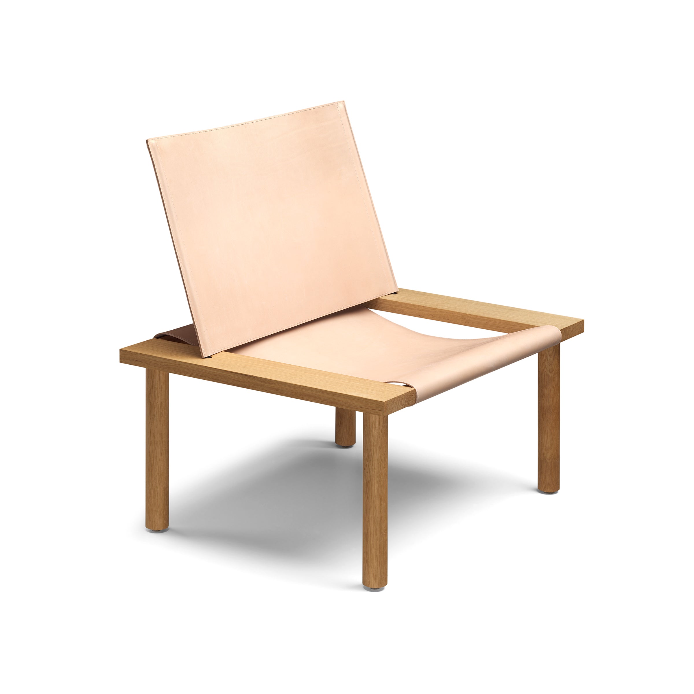 The EC06 ILMA Lounge Chair by E15 features a solid wood frame and light tan harness leather seat and backrest. Its minimalist design includes wide legs and an angular structure, all set against a white background.