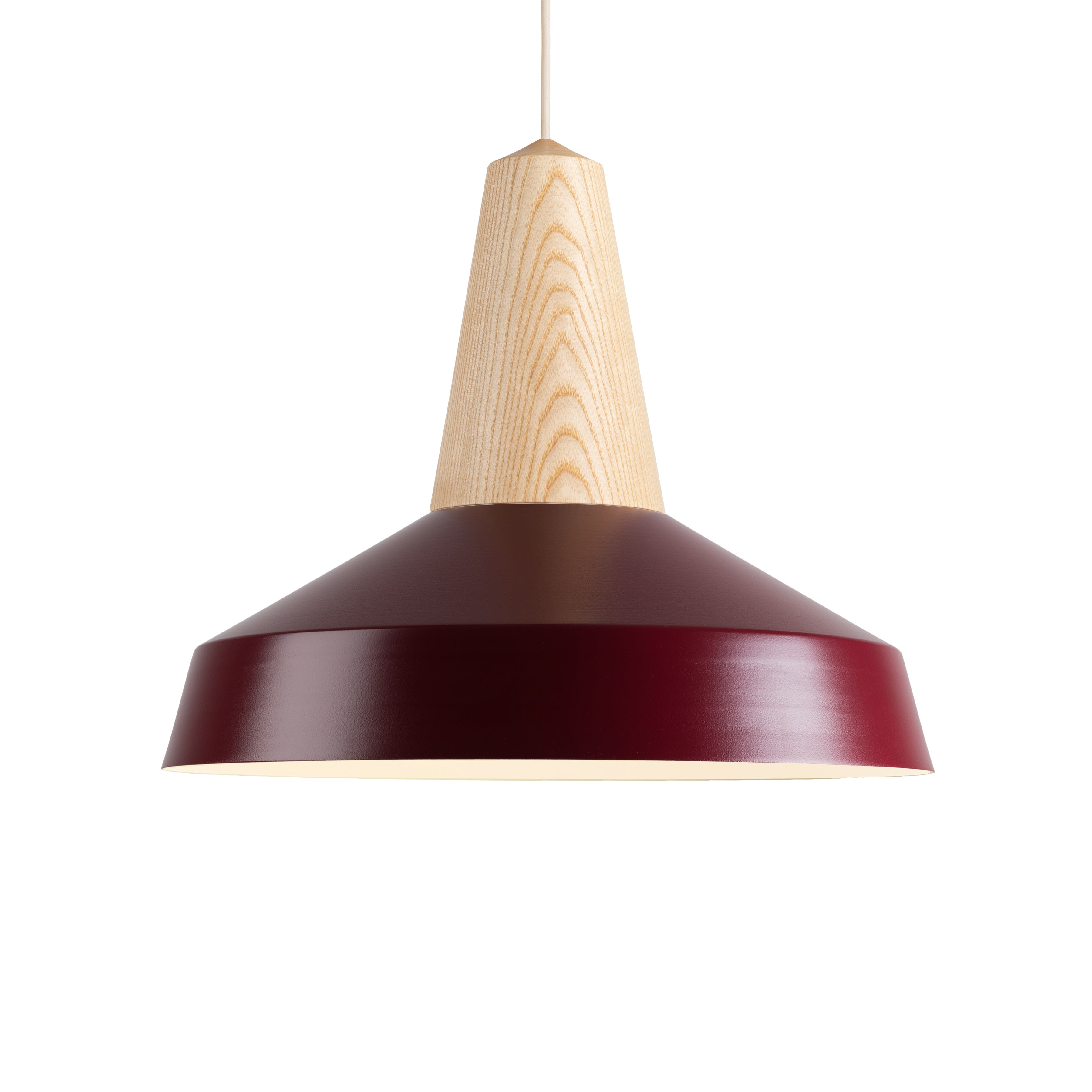 The Eikon Circus Burgundy by Schneid has a sleek, conical wooden top paired with a wide maroon shade. Hanging from a white cord, it blends contemporary flair and natural wood texture for an industrial charm.