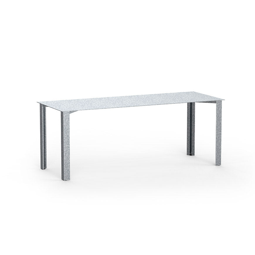 The PILON Table by Echtstahl features a sleek, modern design with a smooth rectangular top and four straight legs. Crafted from light gray sheet steel, it includes height-adjustable feet for convenience, all set against a plain white background.