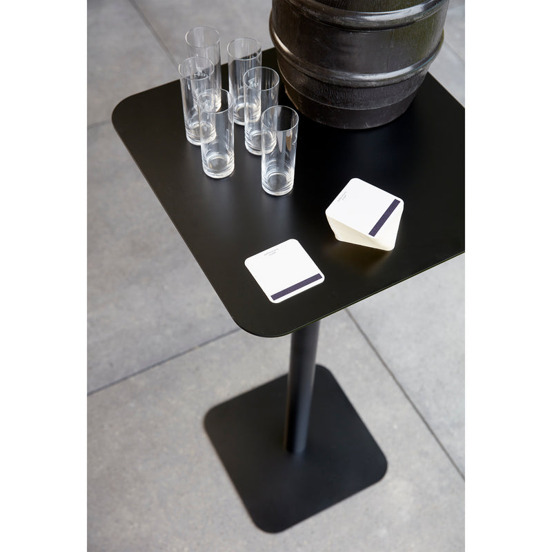Echtstahls Side Table 123, crafted from powder-coated steel, holds six clear glasses, two white coasters with black stripes, and a large metallic container. Featuring a black square design and minimalistic style, it is suitable for both indoor and outdoor tiled floors.