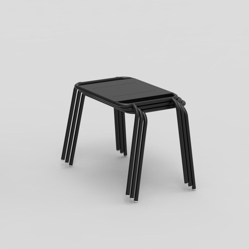 A stack of three modern Echtstahl Hama Stools, showcasing a sleek black design with curved stainless steel legs, arranged on a plain gray background.