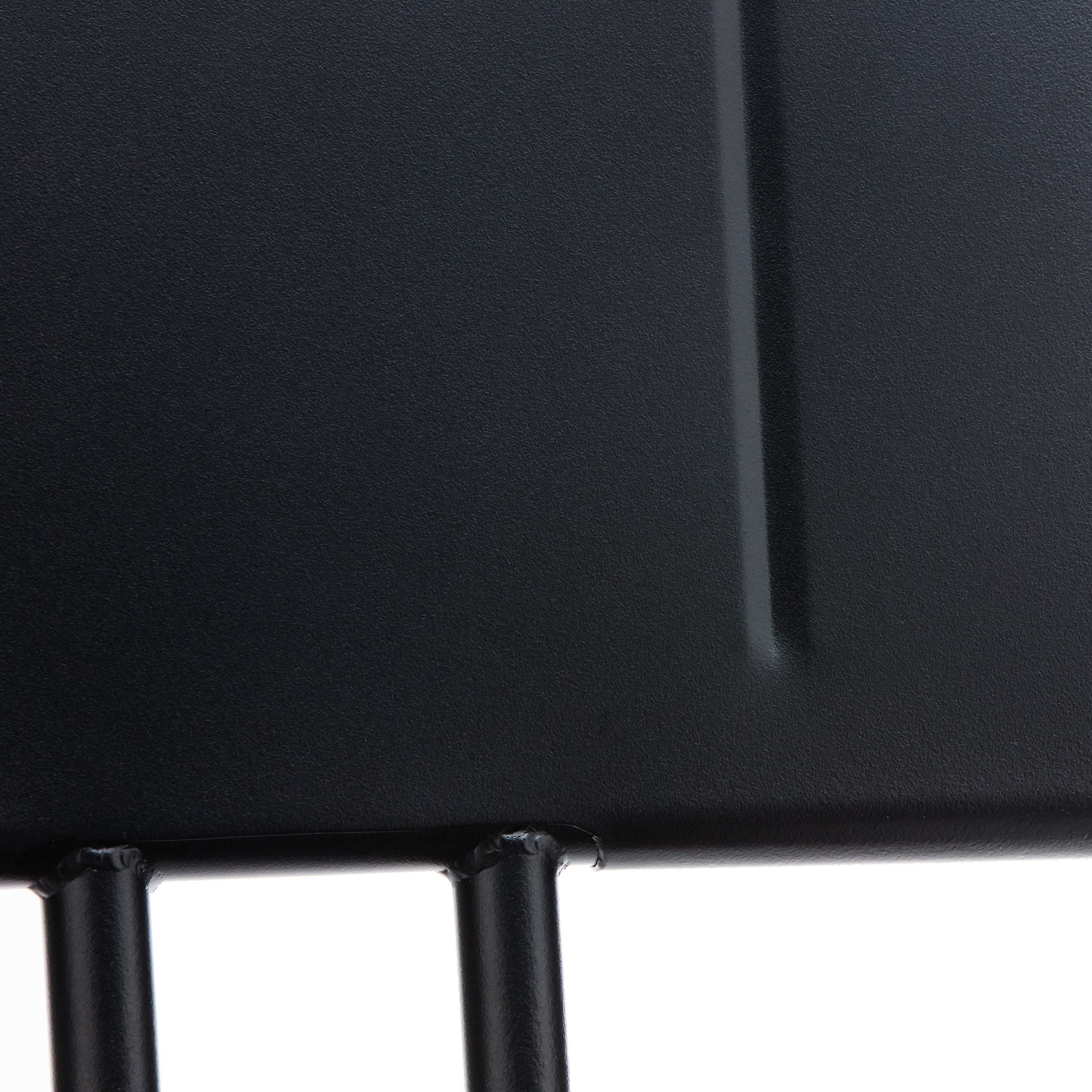 Close-up of the Hama Chair by Echtstahl, a black metal structure resembling stainless steel with vertical rods joining a flat panel. The cylindrical design and smooth finish highlighted by lighting make it perfect for chic outdoor seating.