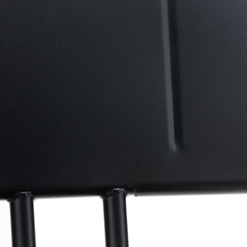 Close-up of the Hama Chair by Echtstahl, a black metal structure resembling stainless steel with vertical rods joining a flat panel. The cylindrical design and smooth finish highlighted by lighting make it perfect for chic outdoor seating.