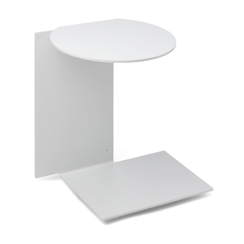 The Plateau side table by Echtstahl is a minimalist piece made from powder-coated steel, featuring an L-shaped design with a round top and square bottom platform. Its sleek, modern look is ideal for displaying small items or decor, making it a versatile addition to any space.