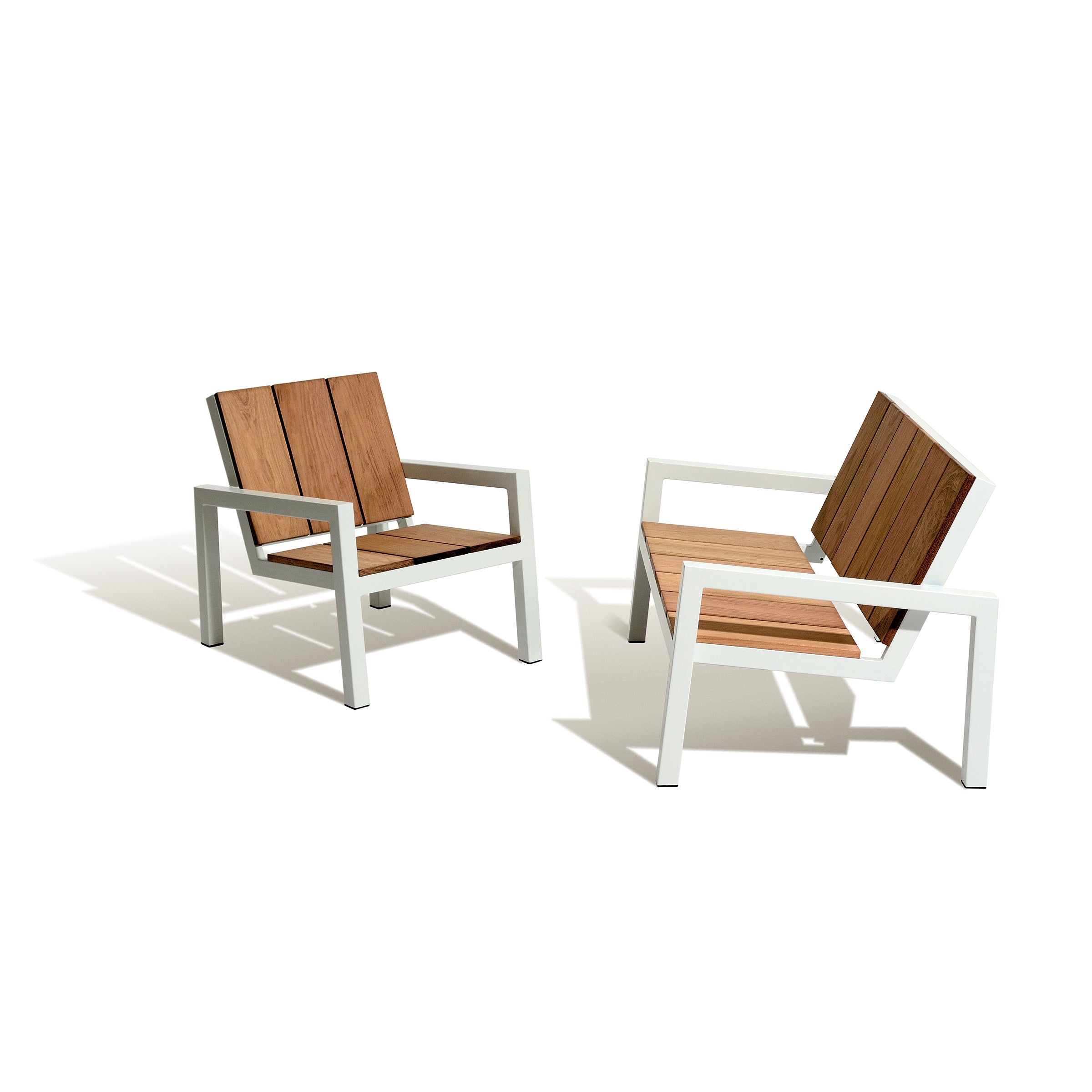The Laurede Lounge Chairs by Egoe boast white metal frames and tropical wood slats, angled against a plain white background. Their sleek design casts subtle shadows, making them perfect as sophisticated garden furniture.