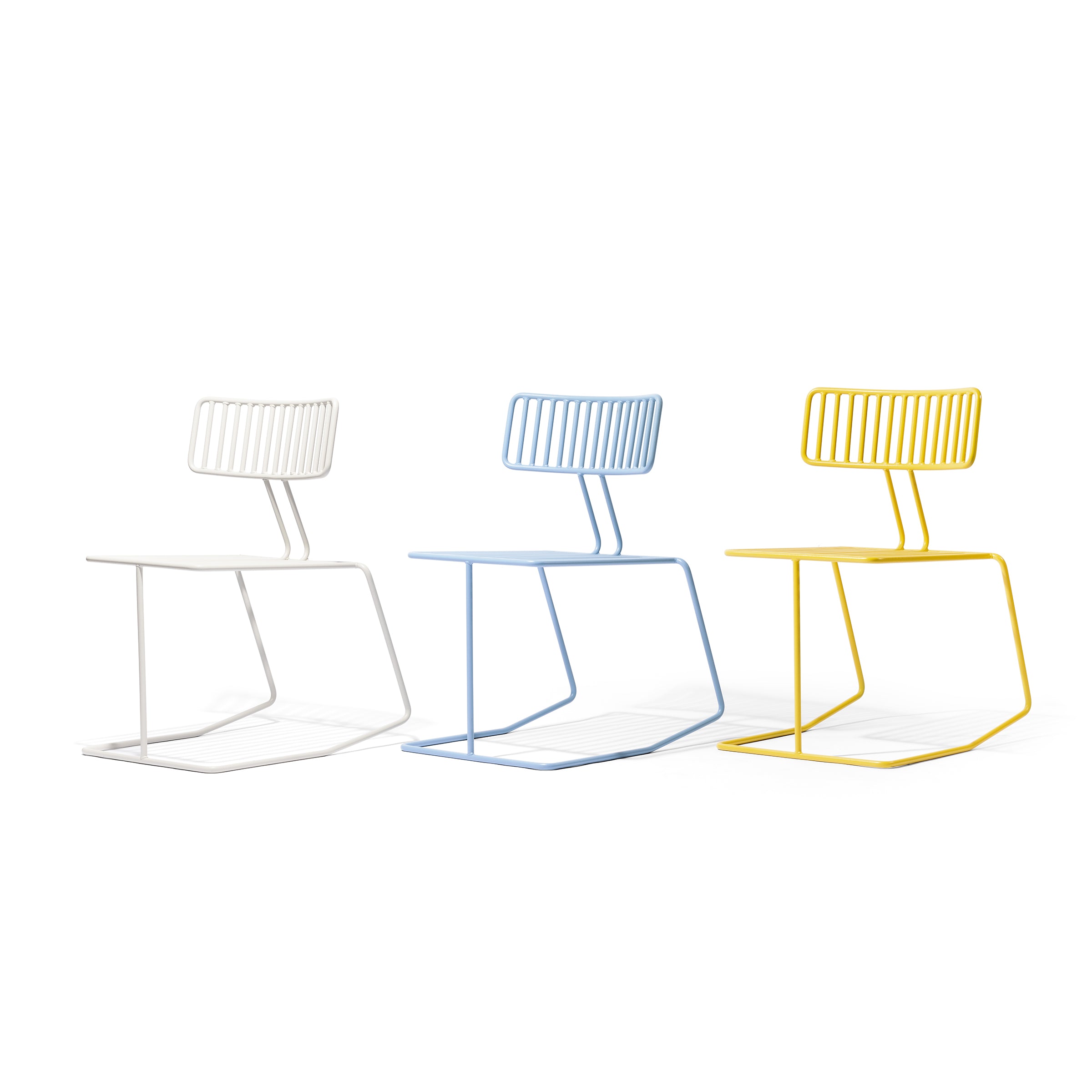 Three Egoé Hope chairs, with a minimalist geometric design, arranged in white, light blue, and yellow with unique slanted backrests and cantilevered bases, stand against a plain white background.