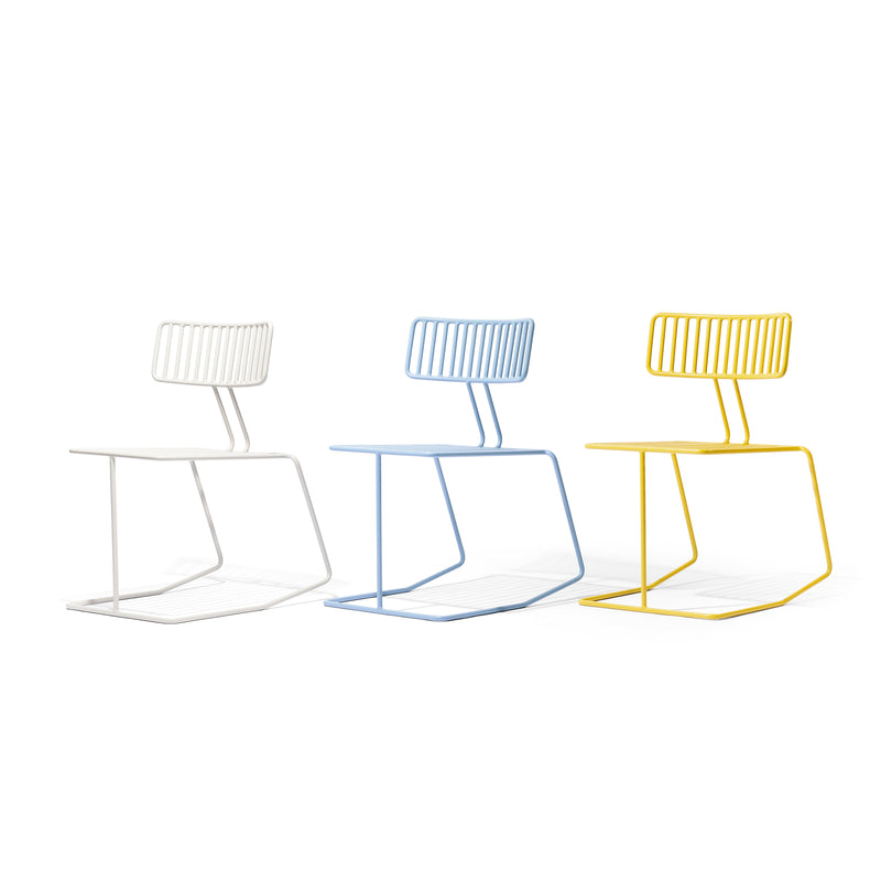 Three Egoé Hope chairs, with a minimalist geometric design, arranged in white, light blue, and yellow with unique slanted backrests and cantilevered bases, stand against a plain white background.