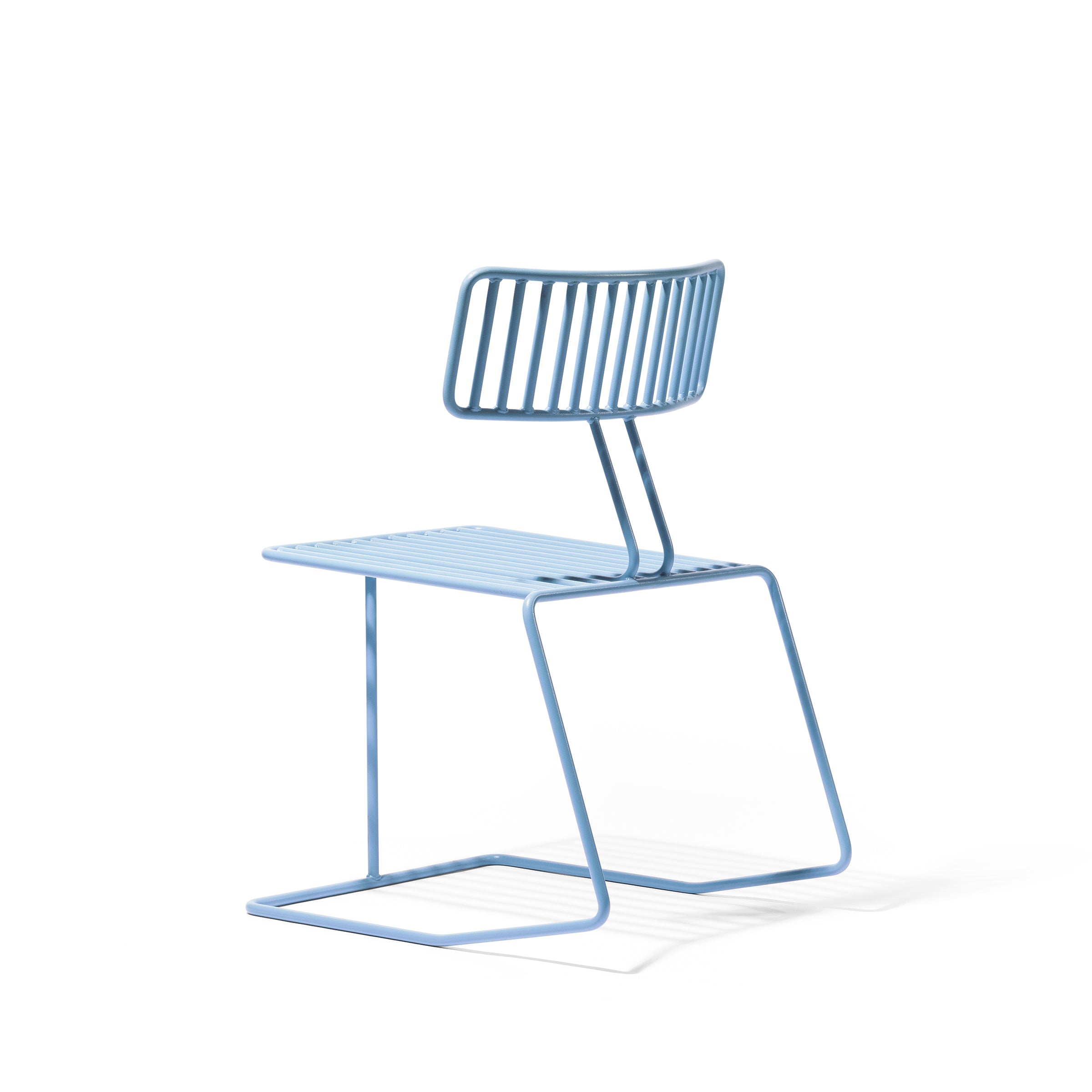 Egoés Hope Chair is a minimalist blue metal piece with a geometric design, featuring a slatted backrest and seat. Its cantilevered base offers an elegant modern touch, creating an airy look against white surroundings.