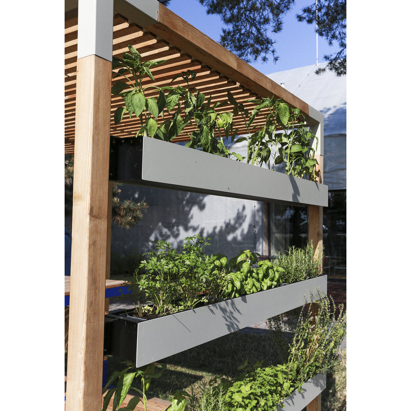 The Egoe Leva Office and Classroom system features a three-tier vertical garden with lush greenery, supported by an elegant wooden frame. Set outdoors on a sunny day, nearby trees cast gentle shadows, creating a serene outdoor office space.
