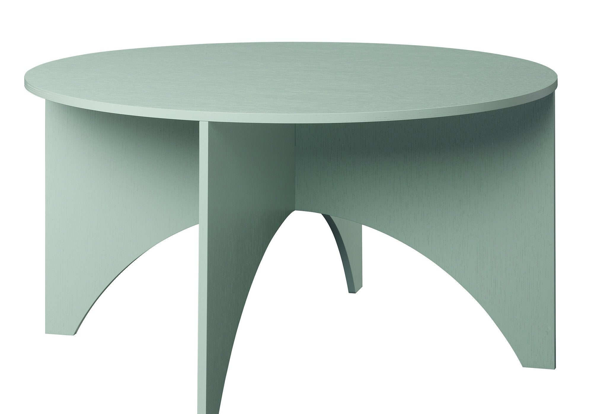 The FK05 CHARLOTTE, now on sale by E15, is a round mint-green coffee table inspired by Ferdinand Kramer with minimalist design and four elegantly curved legs intersecting beneath the smooth top for a modern aesthetic.