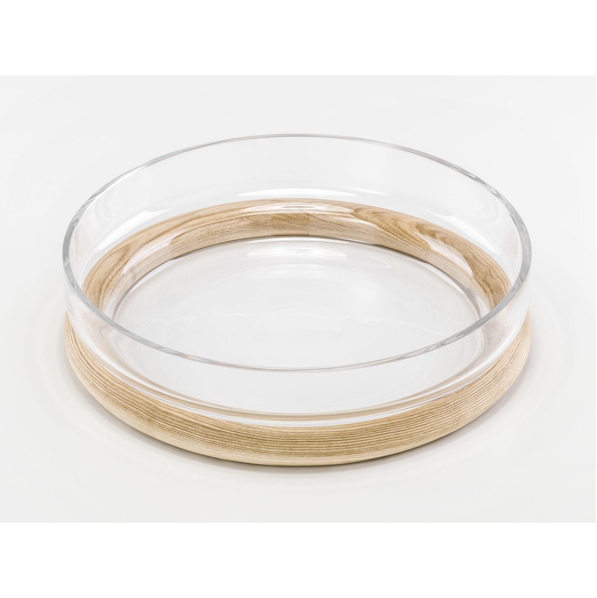 The Hoop Bowl by TON, a clear glass serving bowl with a light bent wood base, showcases a smooth and simple design against a white background.
