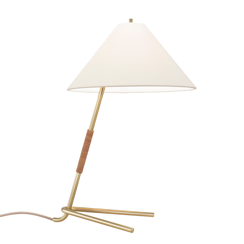 The Hase Table Lamp by Kalmar boasts a polished brass base and shaft, wrapped in brown material at the top. It has a wide conical white shade for ambient lighting, with a power cord included, set against a plain white background.
