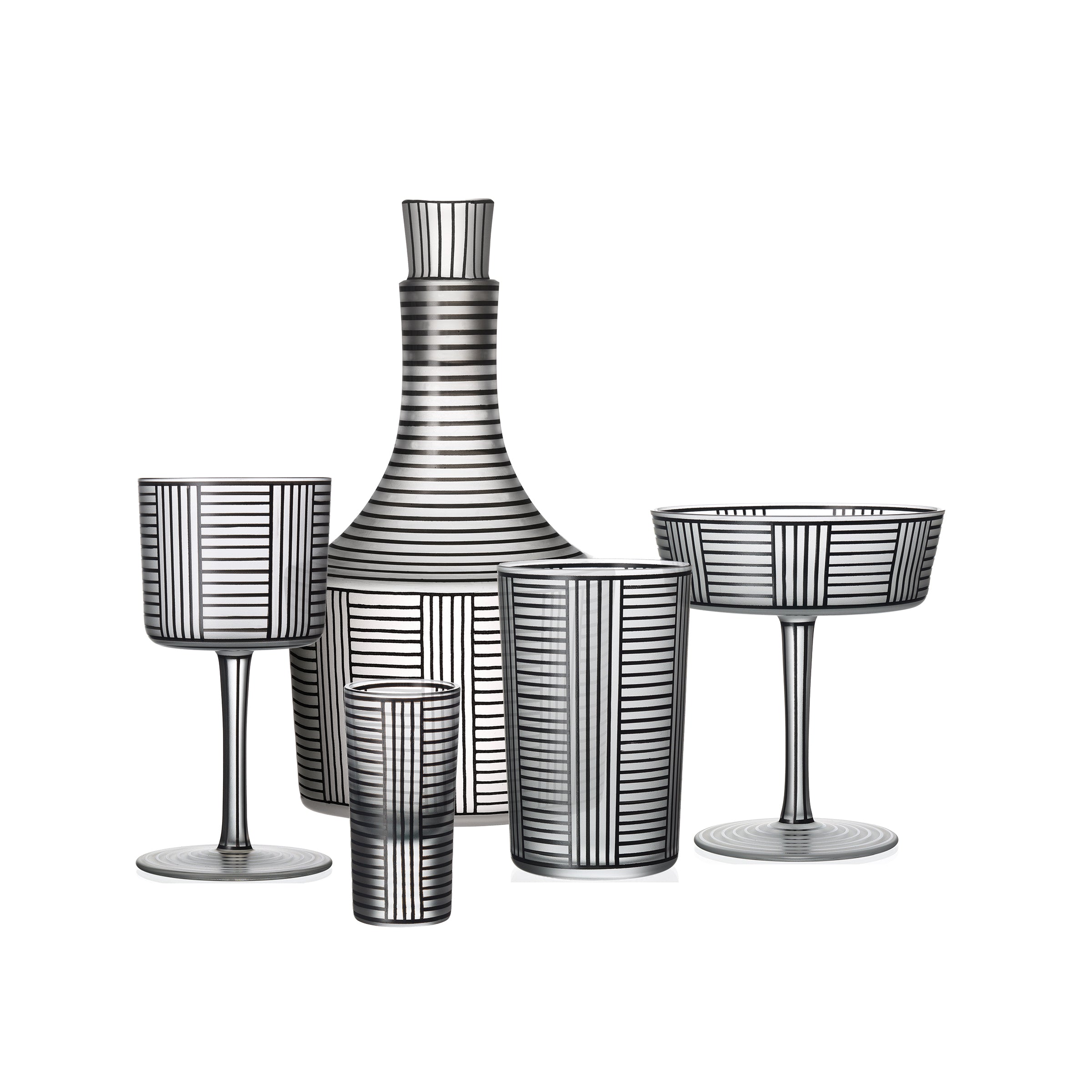 The Drinking Set Serie B by Lobmeyr includes a decanter, two tall glasses, a wide bowl, and a short glass. Made from Lobmeyr crystal, each piece showcases a monochrome linear striped pattern inspired by Josef Hoffmann for an elegant and modern look.