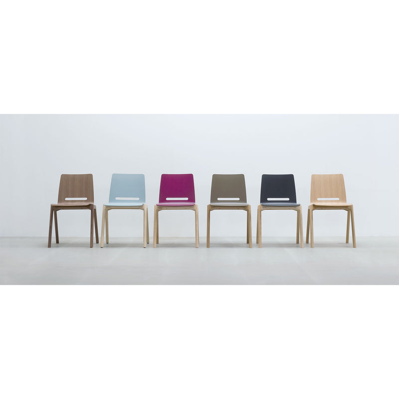 Six stackable Forum 2S chairs by Hussl, featuring minimalist wooden designs, are aligned against a white wall. Each chair has an upholstered seat in brown, light blue, magenta, olive green, black, and light wood hues. They rest on a light gray floor.