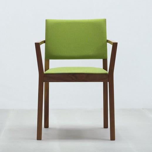 The Hussl ST4N Chair Upholstered is a modern stackable chair featuring a solid wood frame and bright green cushioned seat and backrest, set against a neutral background.