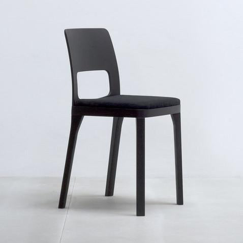 The Hussl ST6N-2 Upholstered chair, with its modern black finish and straight backrest featuring a rectangular cutout, boasts stylish elegance. Perfect for Austrian coffee house settings, it combines comfort and sophistication against a white backdrop.