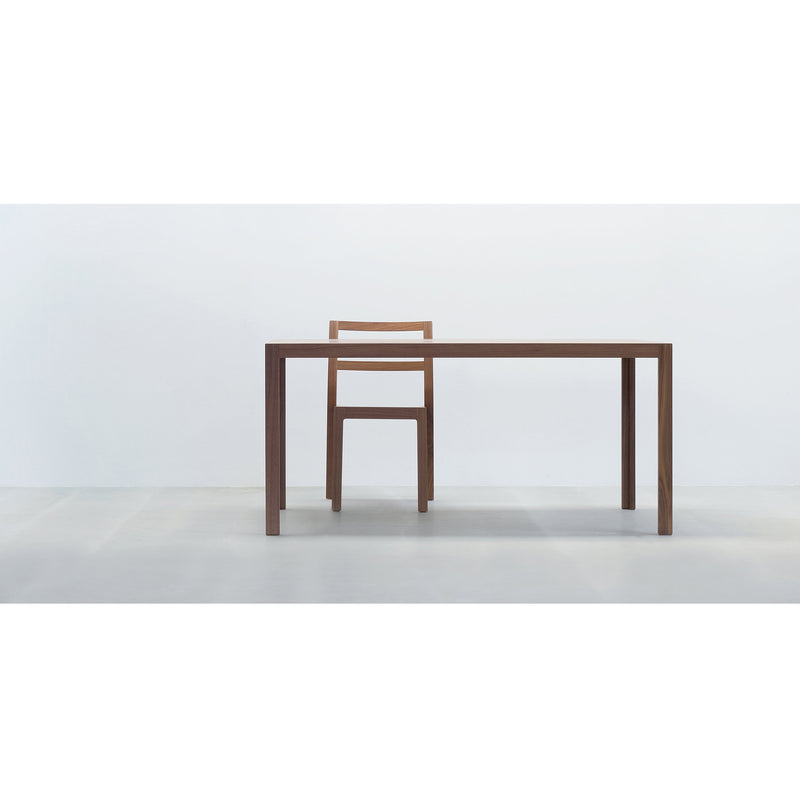 The TC10 table and chair set by Hussl, showcased against a plain white background, features minimalist and clean lines that create a modern look suited for business environments. Its resilient surfaces are highlighted by the neutral floor.