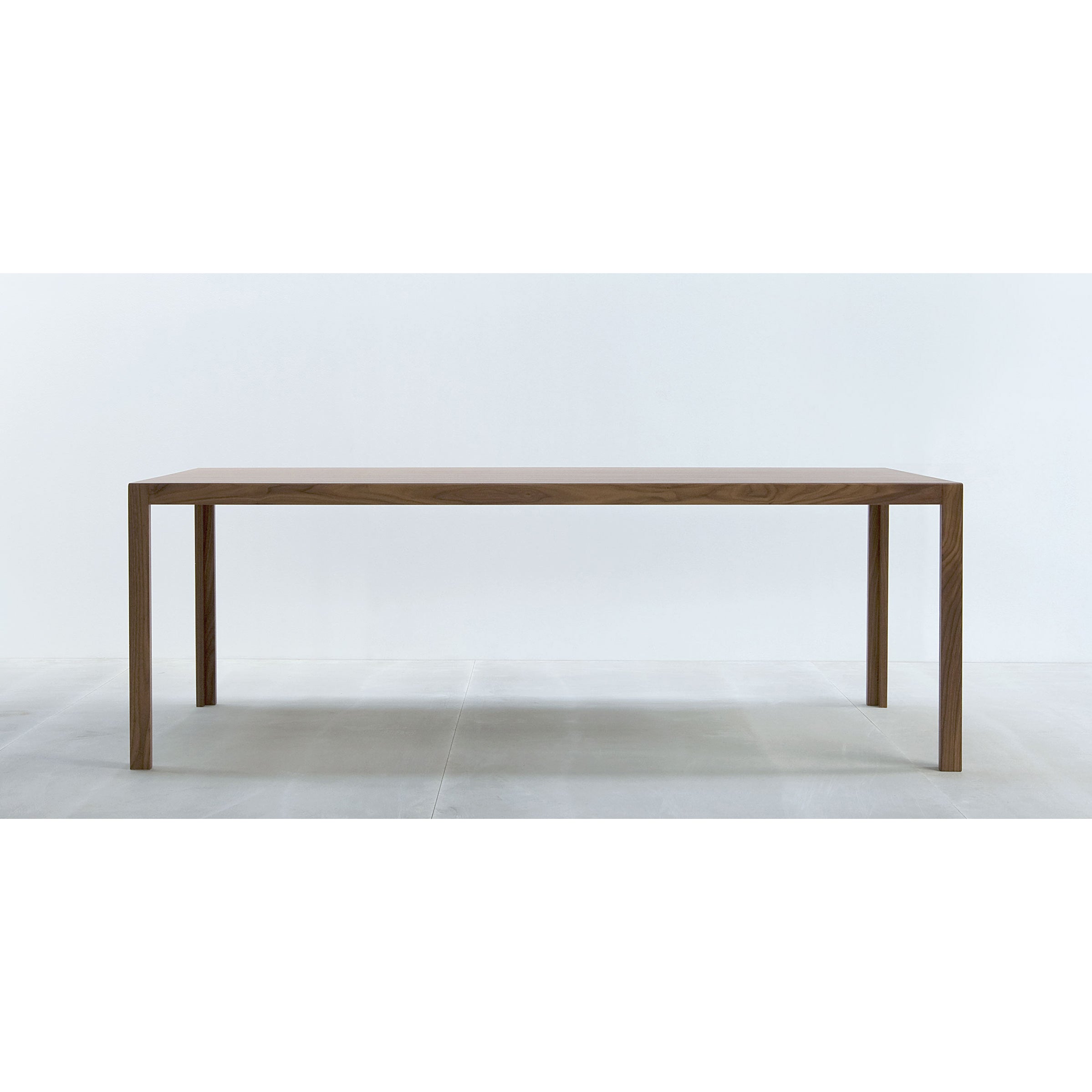 The Hussl TC10 wooden table has a resilient surface, four straight legs, and a rectangular top, set against a white background—ideal for modern business environments.