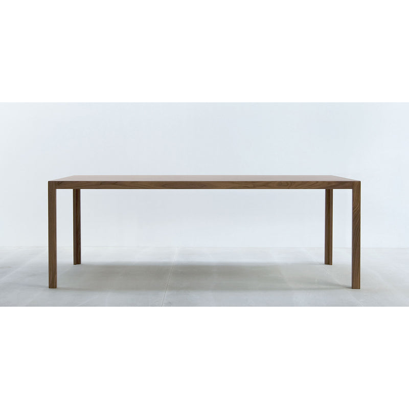 The Hussl TC10 wooden table has a resilient surface, four straight legs, and a rectangular top, set against a white background—ideal for modern business environments.