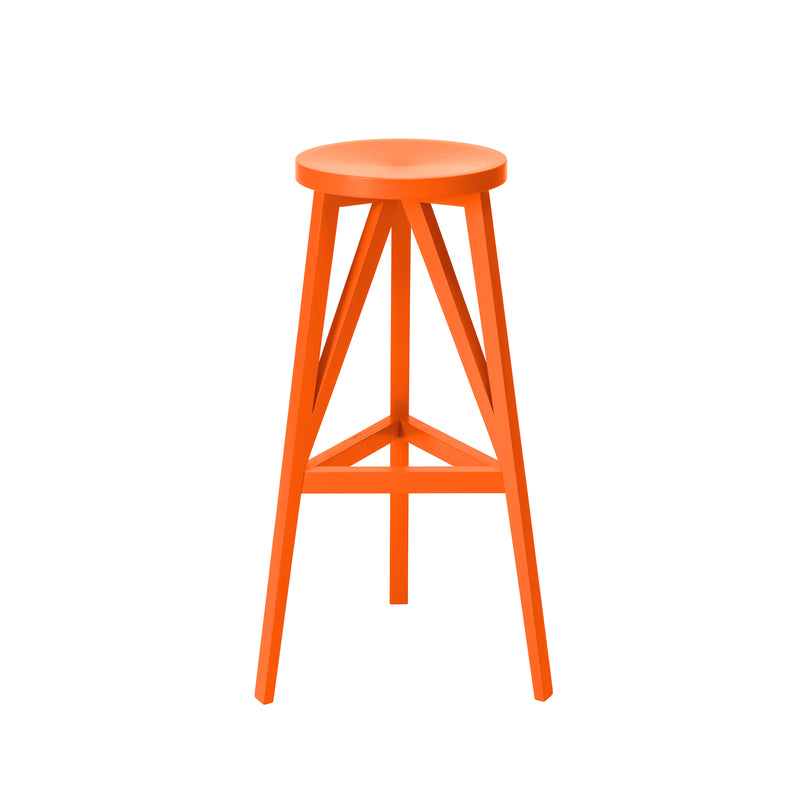 The JL4 Faber Barstool by Loehr is an orange stool with a distinctive silhouette, featuring a circular seat and three legs connected by triangular supports. Crafted from solid oak, its design evokes northern European architecture against a white backdrop.