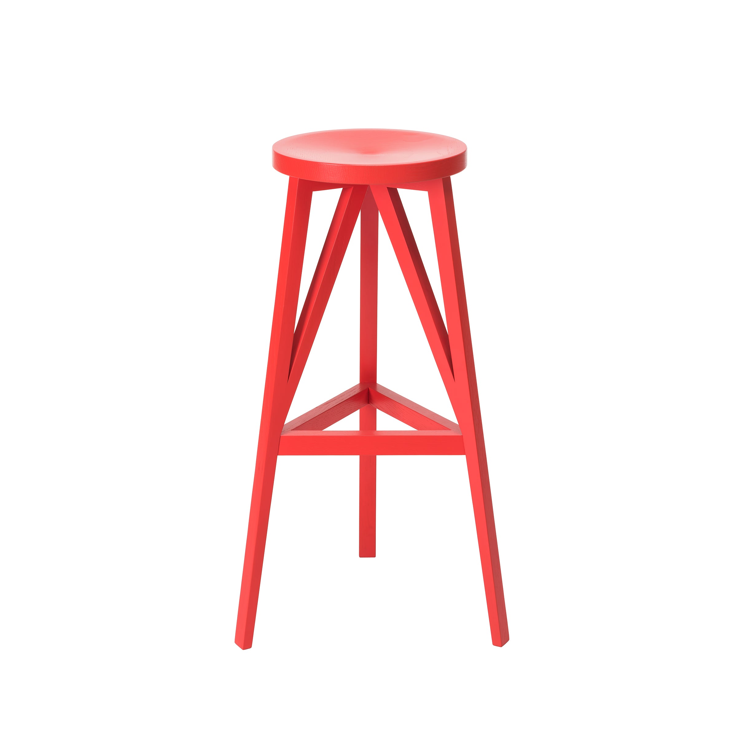 The JL4 Faber Barstool by Loehr is a modern, red wooden stool with a distinctive silhouette. It features a round, flat seat and three legs connected by triangular supports, reflecting northern European minimalist design. The stool is set against a white background for a contemporary look.