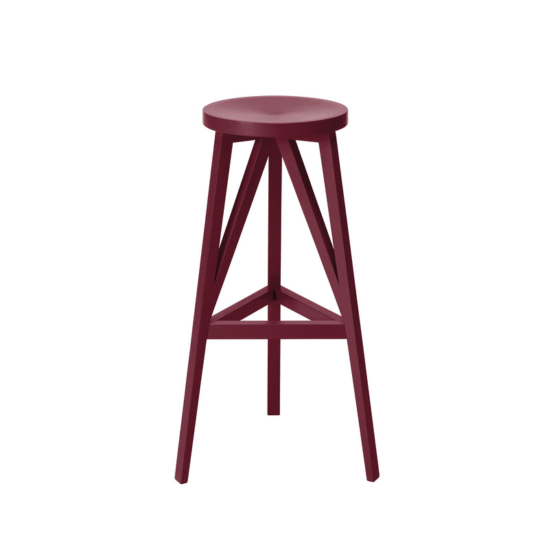 The JL4 Faber Barstool by Loehr is a burgundy wooden stool featuring a round seat, three angled legs connected by horizontal braces, and a minimalist geometric design inspired by northern European architecture, showcasing the beauty of solid oak furniture.