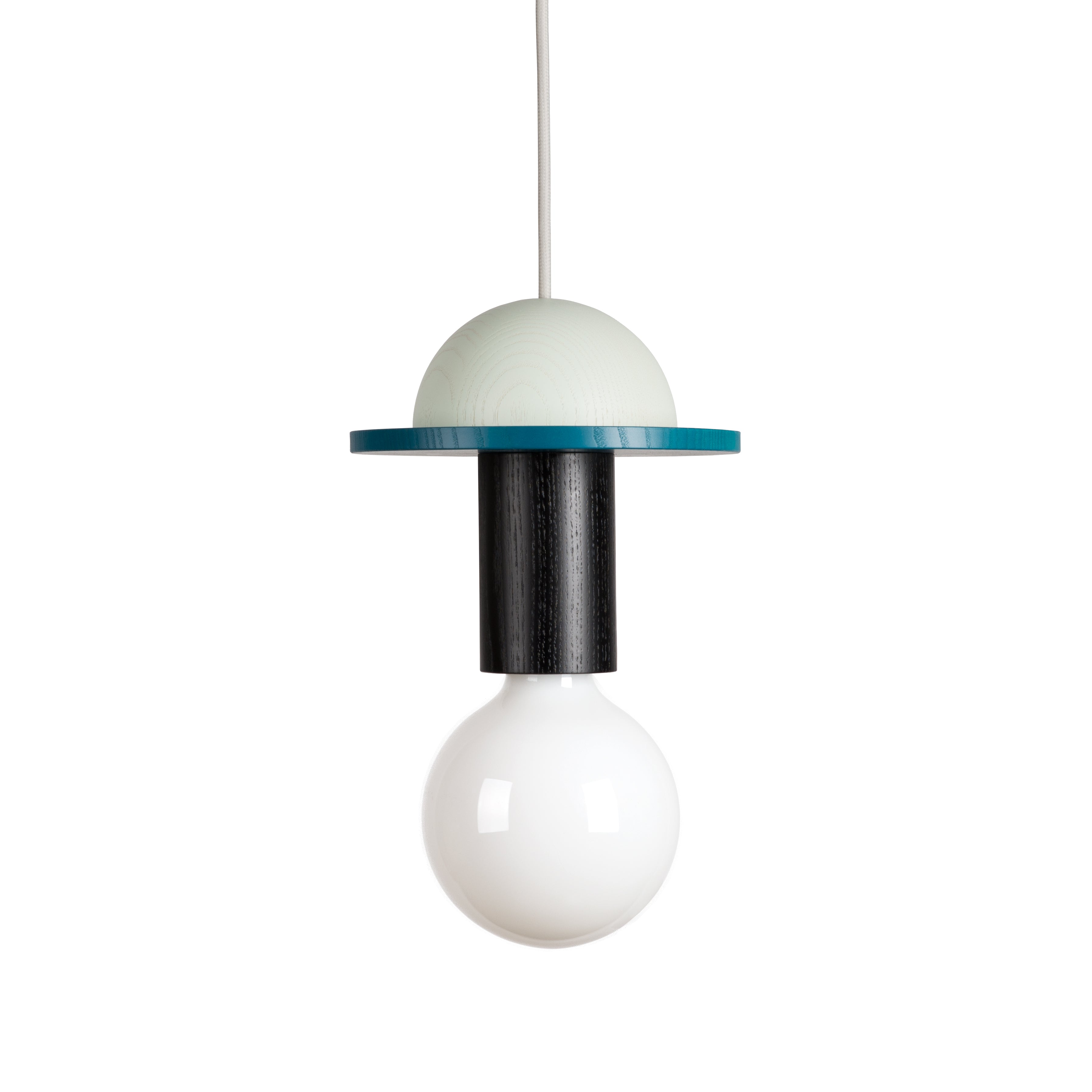 The Junit Crescent by Schneid features a spherical white bulb, cylindrical black fixture, and turquoise disk beneath a half-sphere white shade. It has a modular design hanging from a white cord, offering ambient light against a plain backdrop.