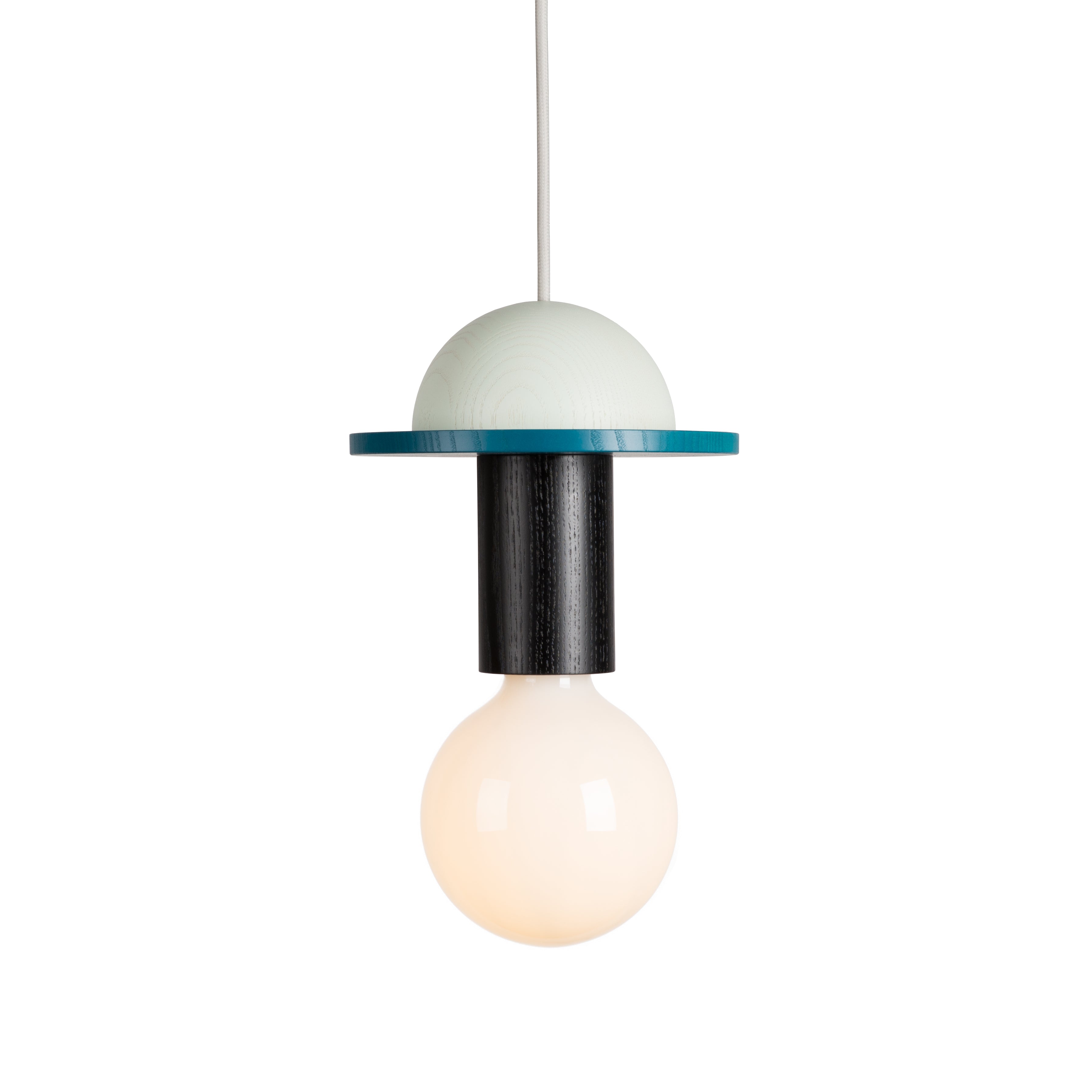 The Junit Crescent by Schneid is a modular pendant lamp with a spherical bulb at the bottom, a cylindrical black center, and a light green dome-shaped top. It features a flat teal disc, is made from high-quality ash wood, and hangs elegantly from a white cord.