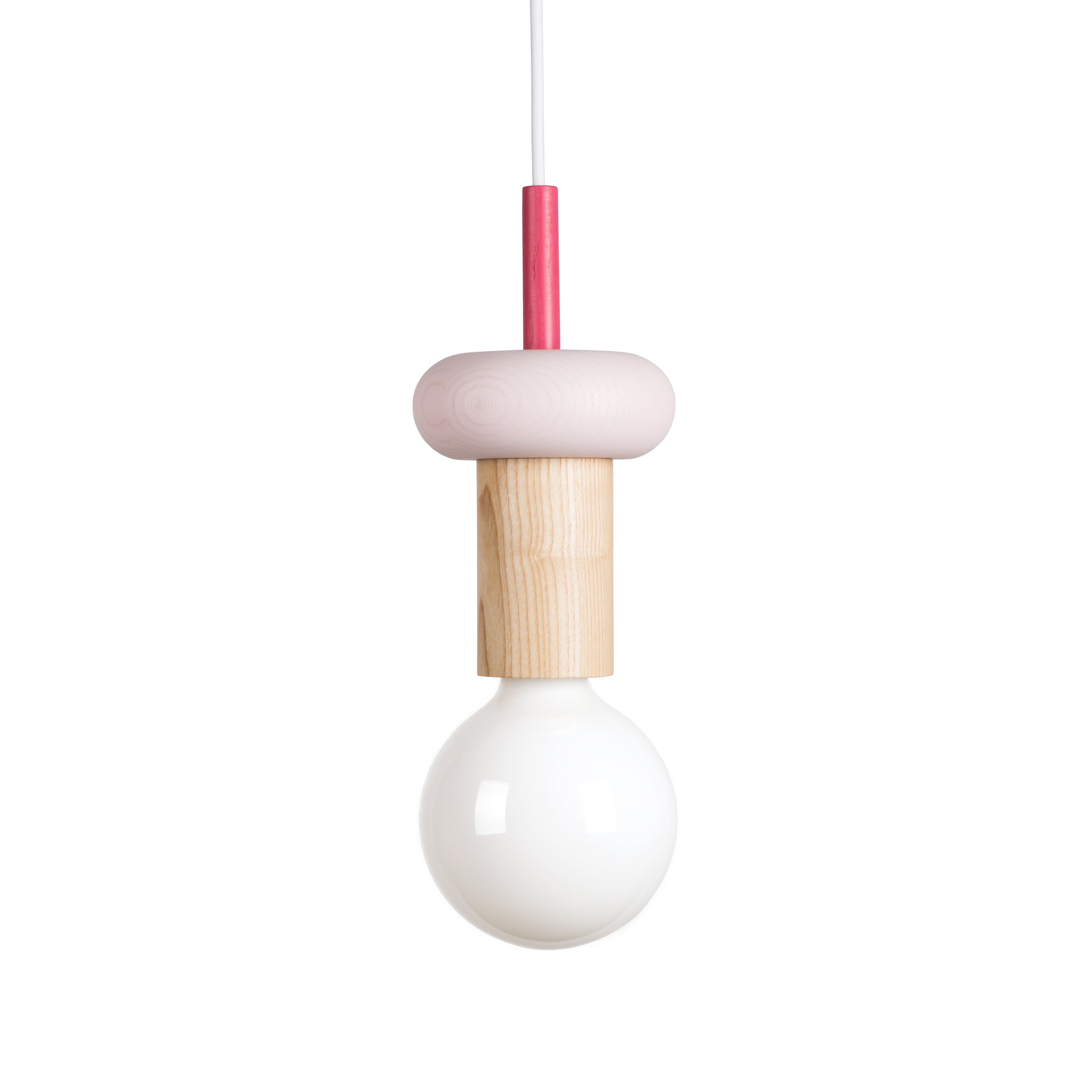 Explore the minimalist allure of the Junit Drop pendant light by Schneid, showcasing a customizable design with a large round bulb and ash wood cylindrical holder. A pink circular top and sleek cord make it ideal for contemporary spaces needing modern elegance.