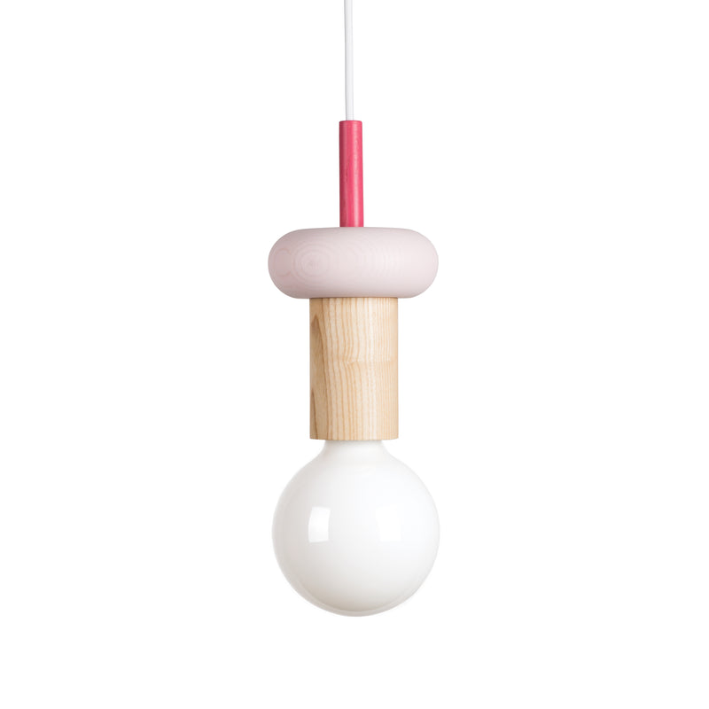 Explore the minimalist allure of the Junit Drop pendant light by Schneid, showcasing a customizable design with a large round bulb and ash wood cylindrical holder. A pink circular top and sleek cord make it ideal for contemporary spaces needing modern elegance.