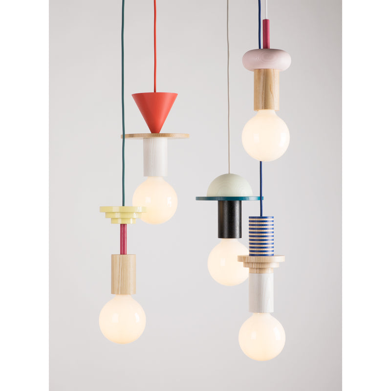 The Junit Mentis collection by Schneid consists of five pendant lights with exposed bulbs. Crafted from ash wood, each features unique geometric designs like cones, cylinders, and rings with colorful cords in vibrant reds, blues, and yellows.