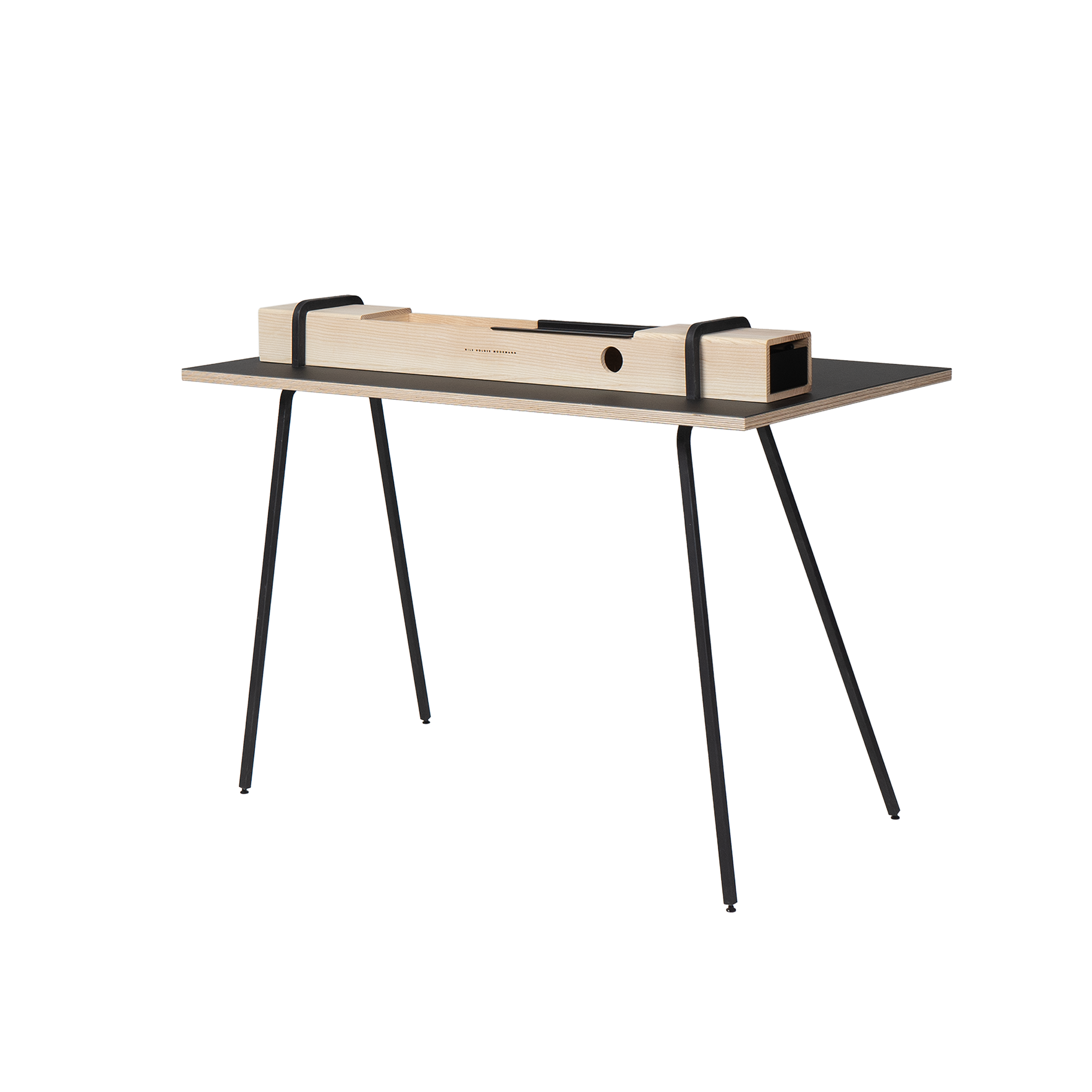 The Kurt by Moormann is a minimalist wooden desk featuring black, slender metal legs and a secretary-style vibe. Its solid wood tabletop includes a rectangular block with two circular cutouts, discreetly secured with black brackets for stylish storage.