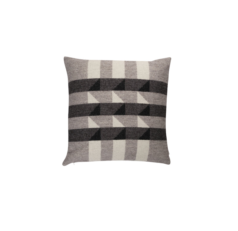 The Kvam Cushion by Roros is a square throw pillow featuring a geometric pattern with alternating diagonal stripes and triangles in gray and black on a light background, perfectly complementing your Norwegian lambswool blanket collection.