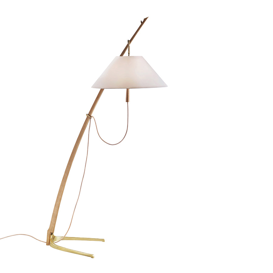 The Dornstab Floor by Kalmar is a modern luminaire featuring a wooden leaning structure with a conical white shade and thin power cord. Its angled base, inspired by the Wiener Werkbund movement, offers an elegant, minimalist design for contemporary spaces.