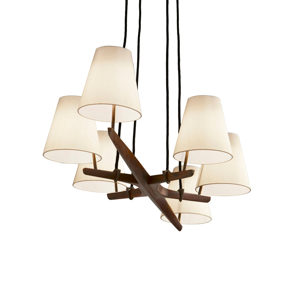 The Admont 6 by Kalmar is a modern chandelier inspired by Wiener Werkbund design, showcasing six white conical lampshades. These shades hang from black cords attached to a central wooden hub for a minimalistic look reminiscent of the Kalmar Werkstätten Admont chandelier.