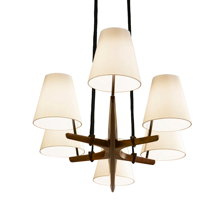 The Admont 6 chandelier by Kalmar, inspired by Kalmar Werkstättens Wiener Werkbund design, includes six white conical lampshades suspended from a black cord with wooden branches. Its modern symmetry accentuates any space.