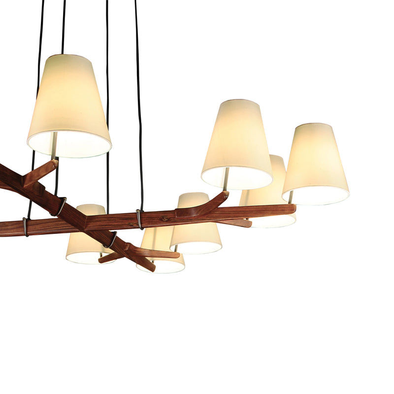 The Holzstern chandelier by Kalmar features a rosewood base with branch-like design, seven conical lampshades, and black cords against a white background.