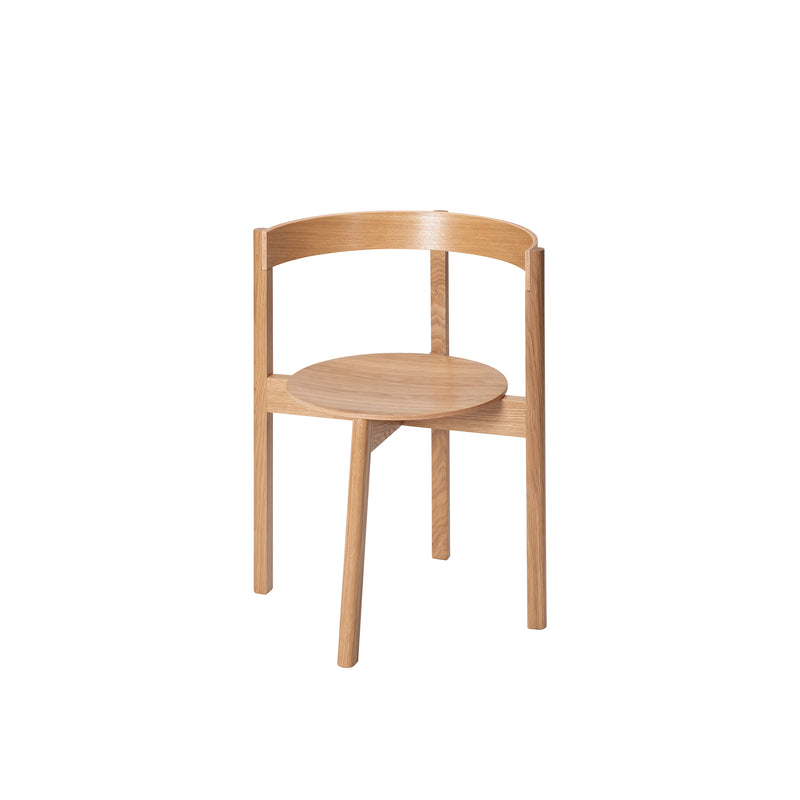 Introducing the L5 JAZZ Armchair by Loehr, a minimalist chair crafted with solid wood. It showcases a round seat and curved backrest supported by three legs, all in a natural wood finish for a simplistic, modern design.