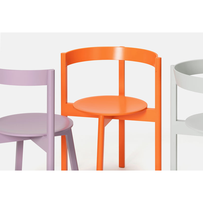 The L5 JAZZ Armchair by Loehr features solid wood construction with circular seats in lavender, orange, and light gray. These modern chairs have minimalist designs and curved backrests, perfect for any stylish dining space.