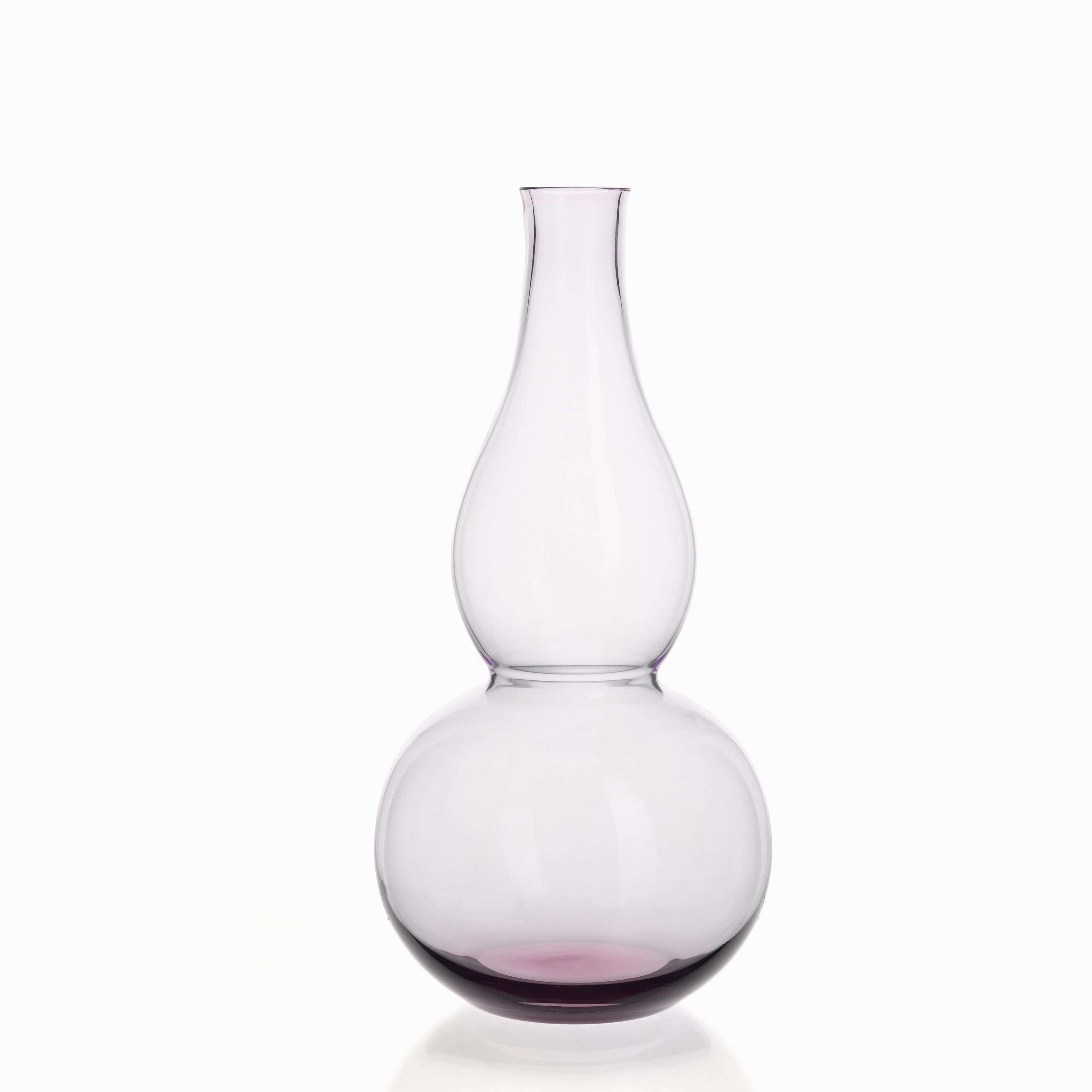 The BV71 Calabash Flower Vase by Lobmeyr features a clear glass design with a narrow neck and wide, round base, echoing the elegance of a calabash gourd. It has a subtle purple tint and is set against a plain white background for an elegant look.