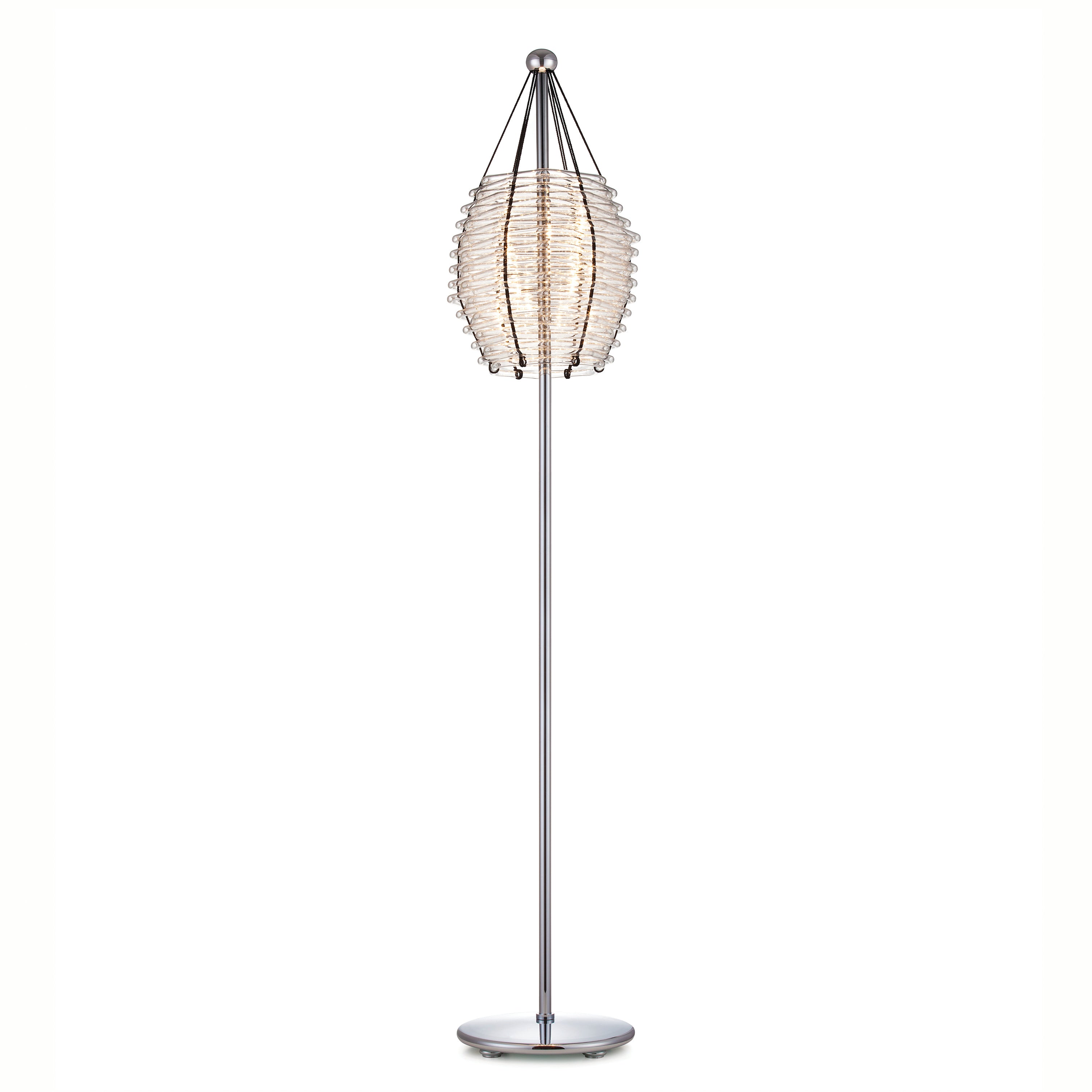 The Basket Floor Lamp by Lobmeyr is a modern piece with a sleek chrome stand and base, featuring a unique cylindrical lampshade of layered translucent rings, similar to bespoke chandeliers, that emits a soft, warm light.