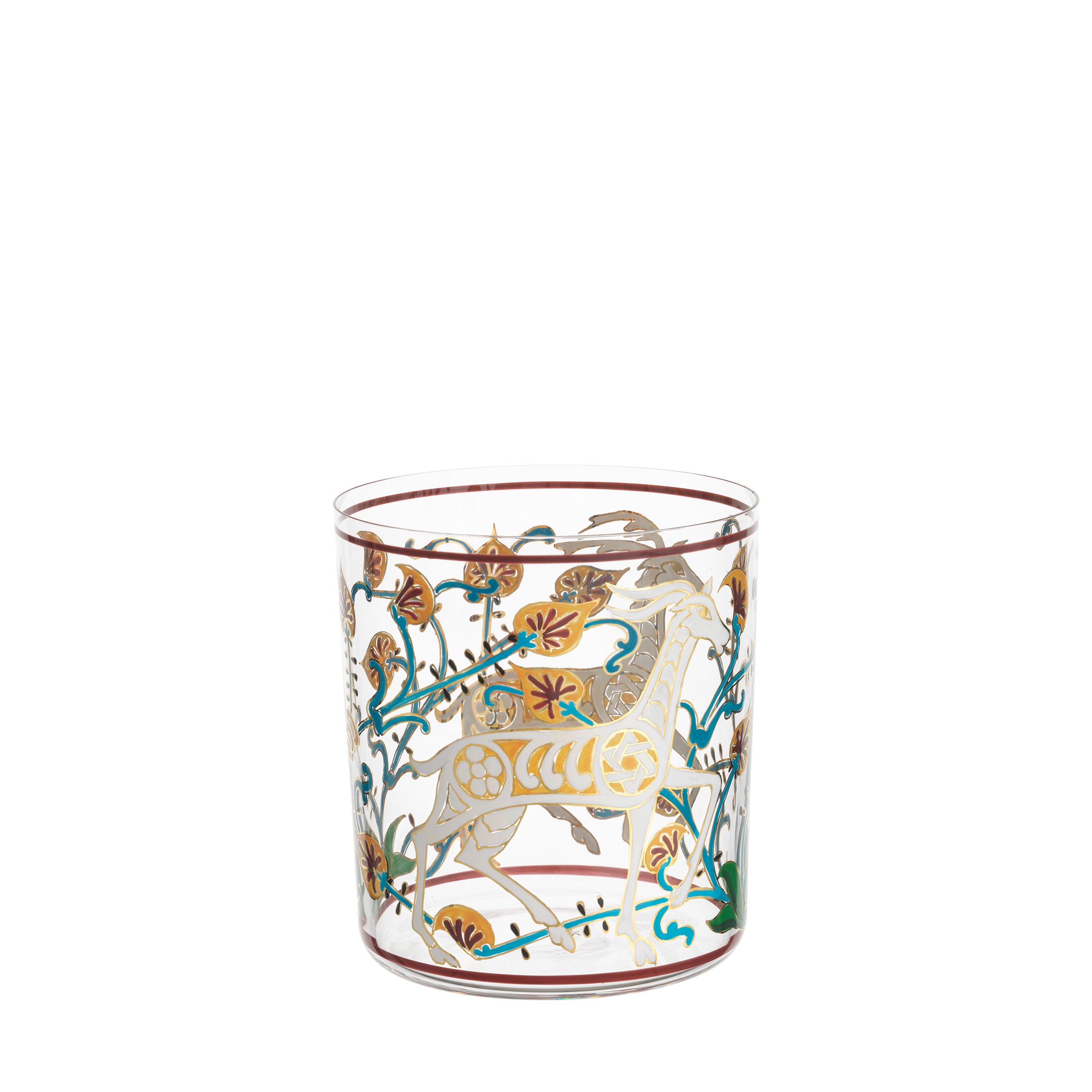 The Lobmeyr Alhambra DOF Tumbler showcases intricate gold designs and colorful accents, featuring a prancing horse in swirling green, gold, and brown foliage. This transparent hand-painted crystal evokes the elegance of the Alhambra Palace.