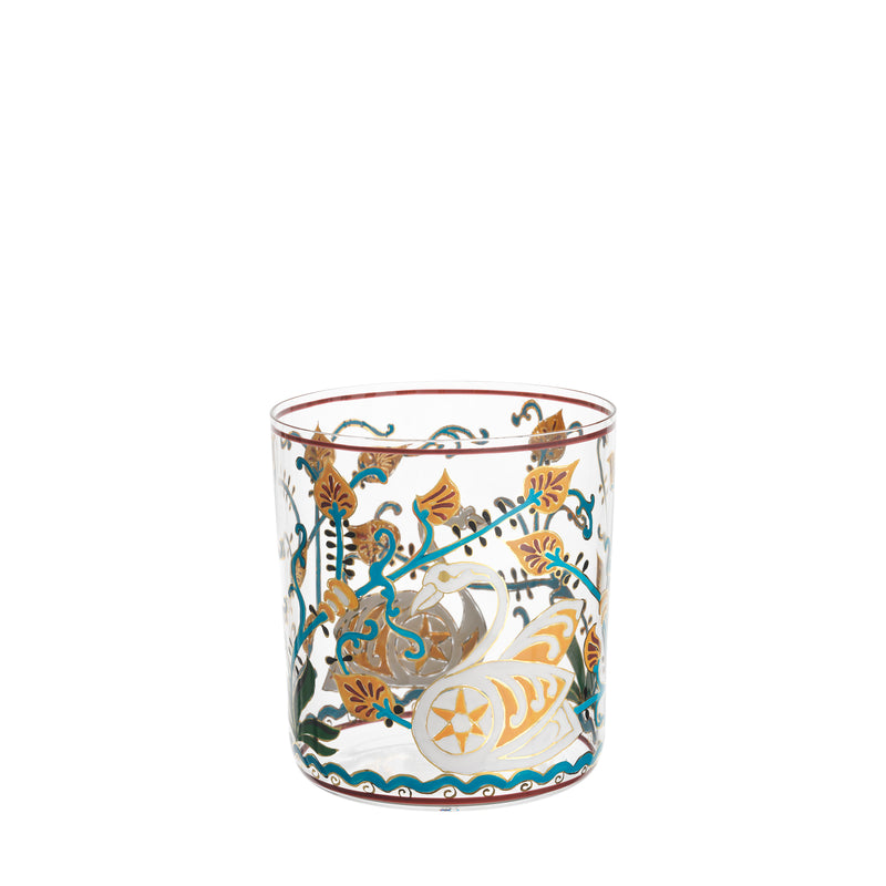 The Alhambra DOF Tumbler by Lobmeyr is a clear glass that reflects the grandeur of the Alhambra Palace with its intricate green, gold, and red floral and geometric motifs, offering an ornate and elegant appearance reminiscent of the Lobmeyr series.