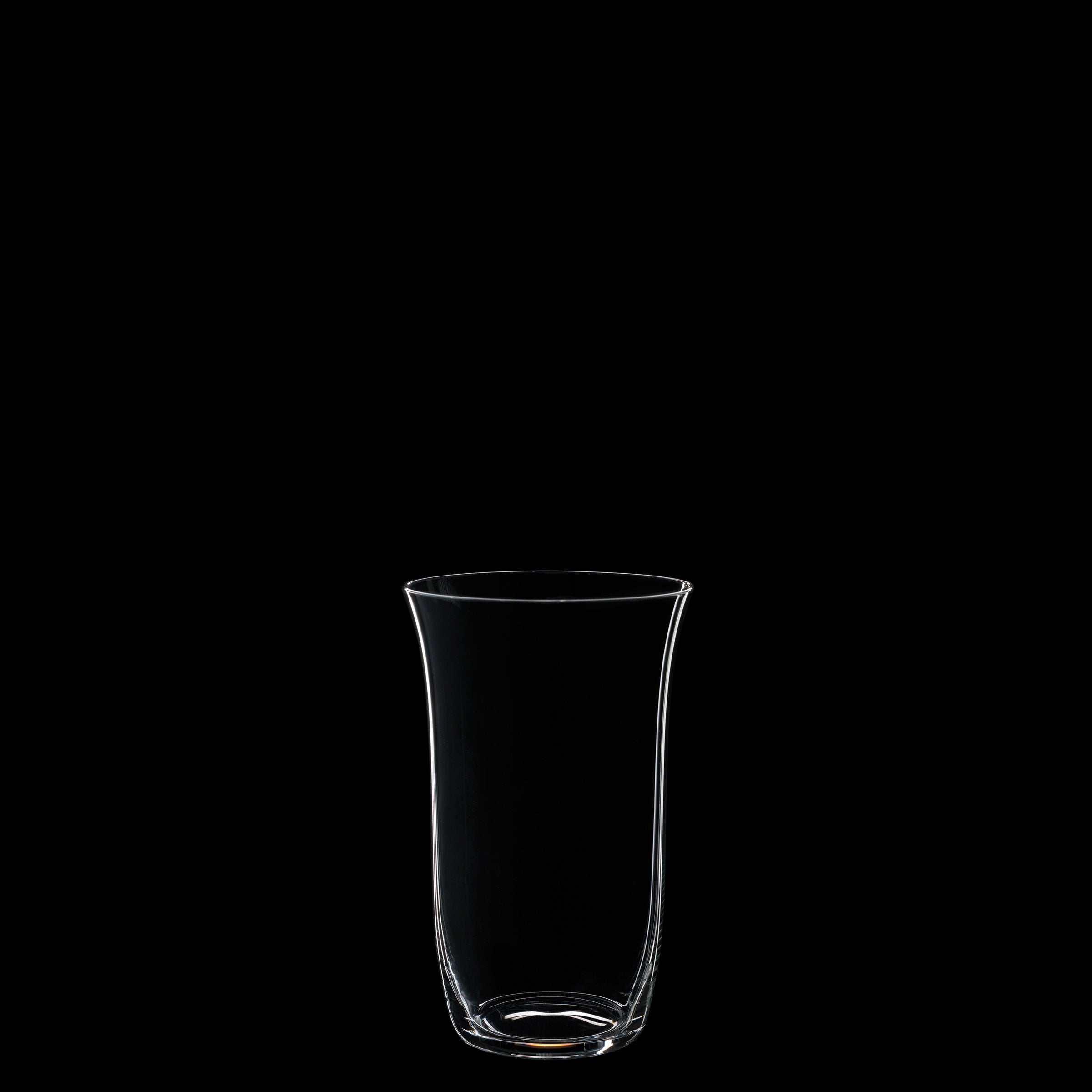 A transparent glass from Lobmeyrs Drinking Set No. 238 - Patrician stands empty against a solid black background, highlighting its smooth, curved design that echoes Josef Hoffmanns artistry.